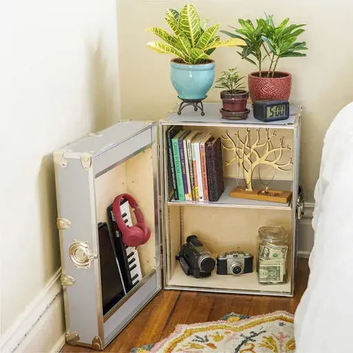 This image provided by Dormify shows a side table. The classic trunk is downsized and transformed into a side table, complete with lockable storage for valuables. (Dormify via AP)
