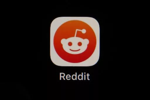 The Reddit app icon is seen on a smartphone, Feb. 28, 2023, in Marple Township, Pa. Reddit is due to begin trading on the New York Stock Exchange on Tuesday, March 21, 2024. (AP Photo/Matt Slocum, File)