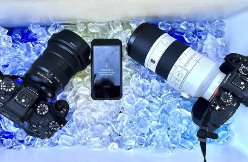 The cameras and cell phone of Associated Press photographer Ross Franklin sit on ice after the devices stopped working after overheating, Thursday, July 20, 2023, in Tempe, Ariz. Phoenix photographers keep coolers for cameras, towels and water in their vehicles when covering extreme heat. (AP Photo/Ross D. Franklin)