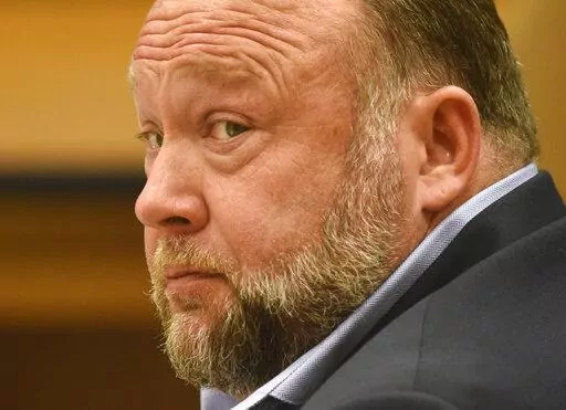 Infowars founder Alex Jones appears in court to testify during the Sandy Hook defamation damages trial at Connecticut Superior Court in Waterbury, Conn. Thursday, Sept. 22, 2022. Jones was found liable last year by default for damages to plaintiffs without a trial, as punishment for what the judge called his repeated failures to turn over documents to their lawyers. The six-member jury is now deciding how much Jones and Free Speech Systems, Infowars’ parent company, should pay the families for