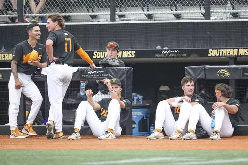 Tennessee players relax during a lightning delay during an NCAA college baseball tournament super regional game against Southern Mississippi in Hattiesburg, Miss., Saturday, June 10, 2023. (James Pugh/impact601.com via AP)