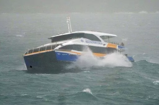 The Manly Ferry makes its way through heavy swells across Sydney Harbour, Australia, Sunday, July 3, 2022. A severe weather warning for heavy rainfall and strong winds has been issued for Sydney, as parts of NSW have received more than their monthly average rainfall within hours this weekend. (AP Photo/Mark Baker)