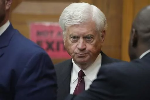 Mississippi Supreme Court Chief Justice Michael Randolph confers with his representation during a recess at a hearing, Wednesday, May 10, 2023, in Hinds County Chancery Court in Jackson, Miss., where a judge heard arguments about a Mississippi law that would create a court system with judges who would be appointed rather than elected. (AP Photo/Rogelio V. Solis)