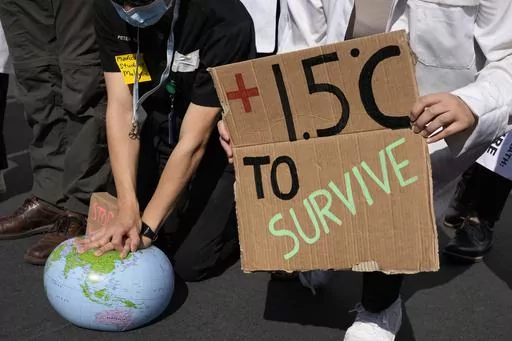 Demonstrators pretend to resuscitate the Earth while advocating for the 1.5 degree warming goal to survive at the COP27 U.N. Climate Summit, Nov. 16, 2022, in Sharm el-Sheikh, Egypt. Worldwide temperatures briefly exceeded a key warming threshold earlier this month, drawing notice from scientists and experts who warned of more extremes ahead as the planet enters an El Nino phase. (AP Photo/Peter Dejong, File)