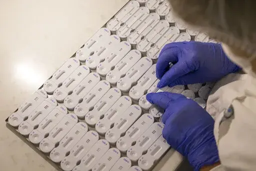 A employees works at NG Biotech, a start-up that makes an array of medical tests, including kits for use at home and by medical professionals to detect COVID-19 infections , in Guipry, western France, Friday, Jan. 7, 2022. With France breaking records in Europe for coronavirus infections, manufacturers are working flat-out to try to meet the huge demand for tests. (AP Photo/Jeremias Gonzalez)