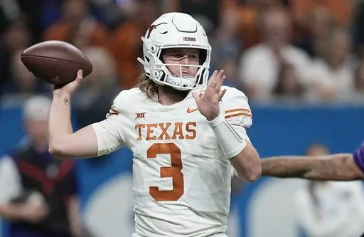 Texas quarterback Quinn Ewers (3) looks to pass against Washington during the second half of the Alamo Bowl NCAA college football game in San Antonio, Thursday, Dec. 29, 2022. Texas wraps spring practice Saturday with the Longhorns' annual scrimmage, allowing the first real look at the biggest quarterback battle in the Big 12 between Ewers, early-enrolled freshman Arch Manning of the famed football family, and second-year reserve Maalik Murphy, a top recruit who spent his freshman season of 2022