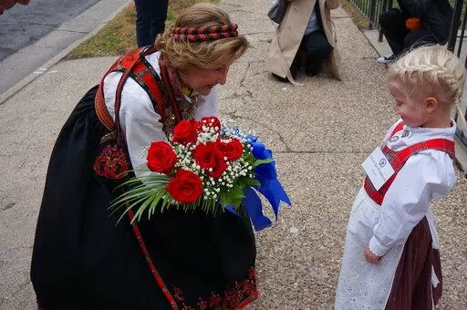 Eline Gro Knatterud, 4, greets Queen Sonja of Norway as she arrives to Den Norske Lutherske Mindekirke, the Norwegian Lutheran Memorial Church in Minneapolis, Sunday Oct. 16, 2022. (AP Photo/Giovanna Dell'Orto)