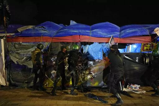 Army soldiers remove tents from the site of a protest camp outside the Presidential Secretariat in Colombo, Sri Lanka, Friday, July 22, 2022. (AP Photo/Rafiq Maqbool)