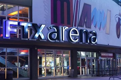 Signage for the FTX Arena, where the Miami Heat basketball team plays, is illuminated Saturday, Nov. 12, 2022, in Miami. Collapsed cryptocurrency trading firm FTX confirmed there was “unauthorized access” to its accounts, hours after the company filed for Chapter 11 bankruptcy protection Friday, Nov. 11.    (AP Photo/Marta Lavandier)