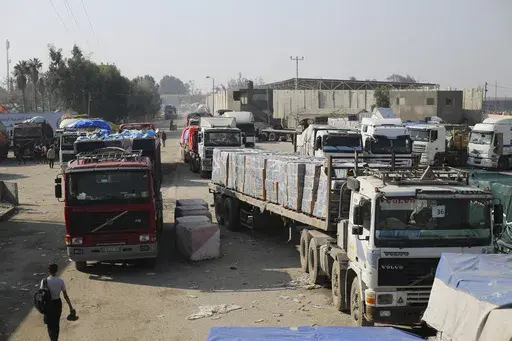 Humanitarian aid trucks enter through the Kerem Shalom crossing from Israel into the Gaza Strip on Monday, Dec. 18, 2023. The Security Council's adoption of a new U.N. resolution to spur desperately needed aid to Gaza has been bogged down by two issues important to the United States — a reference to a cessation of hostilities and putting the U.N. in charge of inspecting trucks to ensure they are actually carrying humanitarian goods. (AP Photo/Hatem Ali, File)