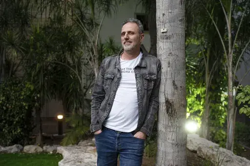 Eitan Gonen, whose daughter Romi was abducted by Hamas militants on Oct. 7, 2023, poses for a portrait in Tel Aviv, Israel, Tuesday, Jan. 28, 2025. (AP Photo/Ohad Zwigenberg)