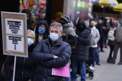 People wait in line at a COVID-19 testing site in Times Square, New York, Monday, Dec. 13, 2021. Scientists are warning that omicron’s lightning-fast spread across the globe practically ensures it won’t be the last worrisome coronavirus variant. And there’s no guarantee the next ones will cause milder illness or that vaccines will work against them. (AP Photo/Seth Wenig, File)