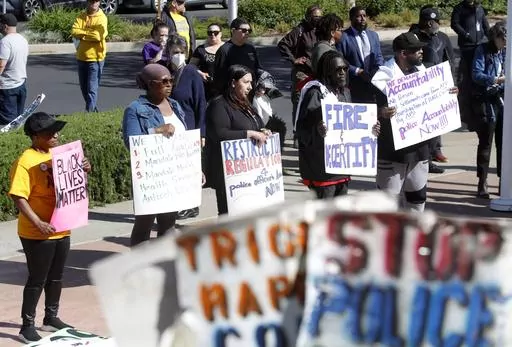 Community members listen to speakers during a rally at Antioch police headquarters in Antioch, Calif., on April 18, 2023. Racist police text messages containing slurs and images of gorillas will take center stage in a San Francisco Bay Area courtroom on Friday, July 21, 2023, as a judge weighs whether the messages violated a state law designed to stamp out racism in the criminal court system. (Jane Tyska/Bay Area News Group via AP)
