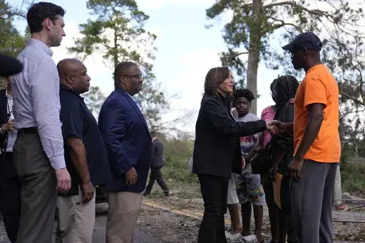 Democratic presidential nominee Vice President Kamala Harris greets people who were impacted by Hurricane Helene in Augusta, Ga., Wednesday, Oct. 2, 2024, as from left, Sen. Jon Ossoff, D-Ga., FEMA deputy direct Erik Hooks and Augusta Mayor Garnett Johnson watch. (AP Photo/Carolyn Kaster)