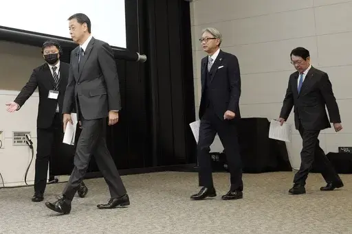 Nissan Chief Executive Makoto Uchida, left, and Honda Chief Executive Toshihiro Mibe, center, and Takao Kato CEO of Mitsubishi Motors, right, arrive to attend a joint news conference Monday, Dec. 23, 2024, in Tokyo, Japan. (AP Photo/Eugene Hoshiko)