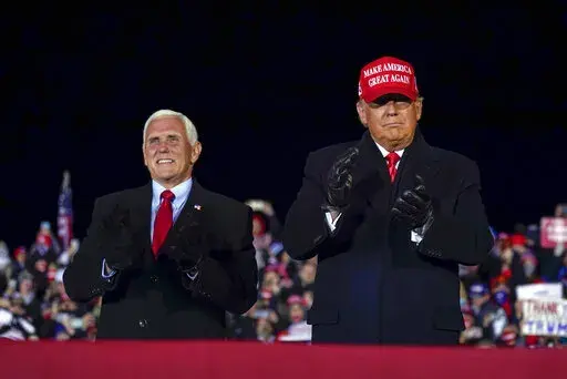 Then-President Donald Trump arrives for a campaign rally at Gerald R. Ford International Airport, Nov. 2, 2020, in Grand Rapids, Mich., with then-Vice President Mike Pence (AP Photo/Evan Vucci, File)