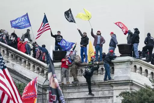 Rioters wave flags on the West Front of the U.S. Capitol in Washington on Jan. 6, 2021. (AP Photo/Jose Luis Magana, File)