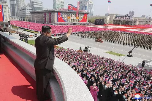 In this photo provided by the North Korean government, North Korean leader Kim Jong Un waves from balcony as he attends a parade to celebrate the 110th birth anniversary of its late founder Kim Il Sung, at the Kim Il Sung Square in Pyongyang, North Korea Friday, April 15, 2022. Independent journalists were not given access to cover the event depicted in this image distributed by the North Korean government. The content of this image is as provided and cannot be independently verified. Korean lan