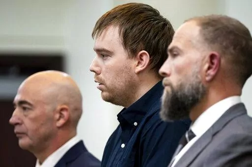 Travis Reinking, center, reacts as the verdict is read during day five of Reinking's murder trial at the Justice A.A. Birch Building in Nashville, Tenn., Friday, Feb. 4, 2022. A jury found Reinking guilty of first-degree murder in the deaths of four people at a Waffle House in 2018. (Andrew Nelles/The Tennessean via AP, Pool)
