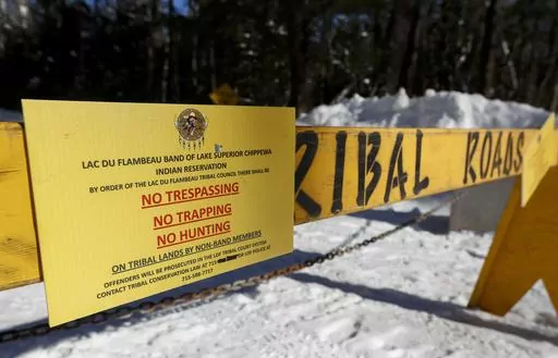 A roadblock is seen along Center Sugarbush Lane on Feb. 8, 2023, at Lac du Flambeau town hall in Lac du Flambeau, Wis. Officials with the town of Lac du Flambeau on Saturday, March, 11, 2023, accepted the Lac du Flambeau tribe’s offer to remove barricades blocking the roads for 90 days in exchange for $60,000 as negotiations continue for a more permanent solution, the Green Bay Press-Gazette reported. (Tork Mason/The Post-Crescent via AP)