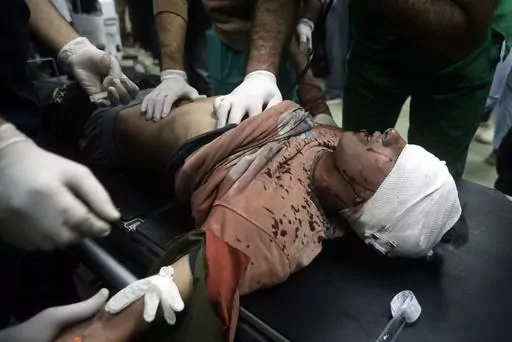 ADDS LOCATION OF BOMBING - A Palestinian wounded in the Israeli bombardment of the Palestinian Red Crescent headquarters receives treatment at the Nasser hospital in Khan Younis, Southern Gaza Strip, Tuesday, Jan. 2, 2024. (AP Photo/Mohammed Dahman)