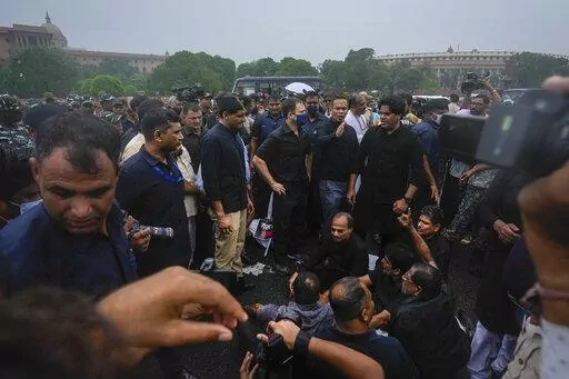 Congress party leader Rahul Gandhi, center in blue mask, and other lawmakers participate in a protest in New Delhi, India, Friday, Aug. 5, 2022. “Democracy is a memory (in India),” Gandhi later tweeted, describing the dramatic photographs that showed him and his party men being briefly detained by police. Gandhi’s statement resonated amid a growing sentiment in the country that India’s democracy, the world’s largest with nearly 1.4 billion people, is in retreat and its democratic found