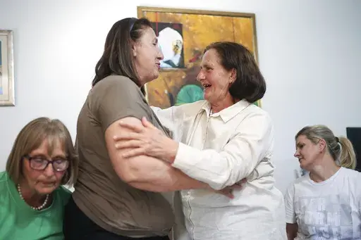 Members of the association Mothers of Srebrenica react after the United Nations General Assembly adopted a resolution declaring July 11 the International Day of Reflection and Commemoration of the 1995 genocide in Srebrenica, in Potocari, Bosnia, Thursday, May 23, 2024. (AP Photo/Armin Durgut)