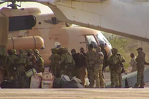 This undated photograph released in April 2022 by France's military shows Russian mercenaries boarding a helicopter in northern Mali. (French Army via AP, File)