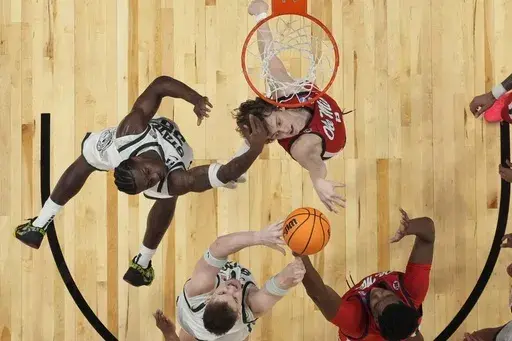 Mississippi guard Eduardo Klafke (8) and Michigan State forward Coen Carr (55) vie for a loose ball during the first half in the Sweet 16 of the NCAA college basketball tournament, Friday, March 28, 2025, in Atlanta. (AP Photo/George Walker IV)