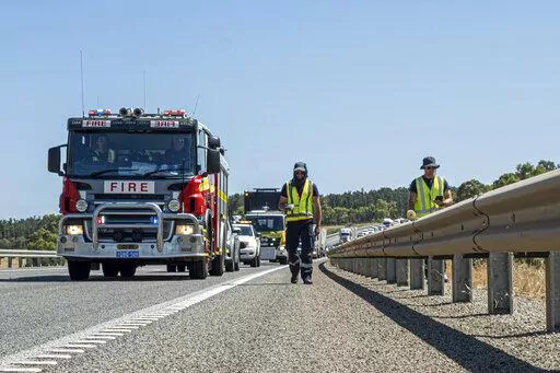 In this photo provided by the Department of Fire and Emergency Services, its members search for a radioactive capsule believed to have fallen off a truck being transported on a freight route on the outskirts of Perth, Australia, Saturday, Jan. 28, 2023. A mining corporation on Sunday apologized for losing the highly radioactive capsule over a 1,400-kilometer (870-mile) stretch of Western Australia, as authorities combed parts of the road looking for the tiny but dangerous substance. (Department 