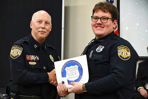 In this photo obtained from the Memphis Police Department's Facebook page, Preston Hemphill receives a certificate from Memphis Assistant Chief of Police Don Crowe after completing the training to join the department's Crisis Intervention Team on July 21, 2022. Police officials said Monday, Jan. 30, 2023, that Hemphill and another officer were relieved of duty in connection with the death of Tyre Nichols, widening the circle of punishment for the shocking display of police brutality after video 