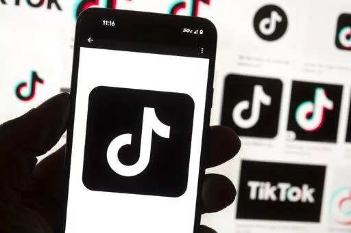 The TikTok logo is seen on a cellphone on Oct. 14, 2022, in Boston. TikTok says every account held by a user under the age of 18 will automatically be set to a 60-minute daily screen time limit in the coming weeks amid growing concerns about the app's security. (AP Photo/Michael Dwyer, File)