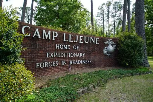 Signage stands on the main gate to Camp Lejeune Marine Base outside Jacksonville, N.C., April 29, 2022. Military personnel stationed at Camp Lejeune from 1975 to 1985 had at least a 20% higher risk for a number of cancers than those stationed elsewhere, federal health officials said Wednesday, Jan. 31, 2024 in a long-awaited study of the North Carolina base's contaminated drinking water. (AP Photo/Allen G. Breed, File)