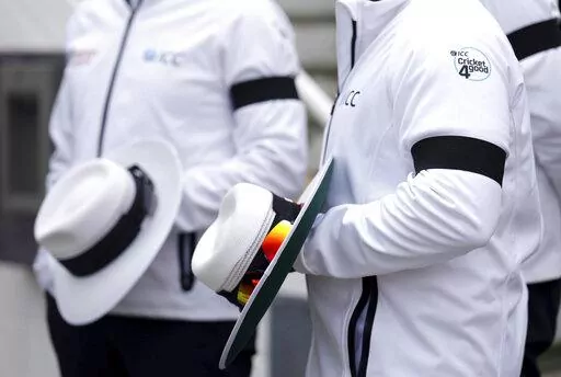 Umpires wearing black armbands on day three of the third LV= Insurance Test match at the Kia Oval, following the death of Queen Elizabeth II, Saturday September 10, 2022.  (John Walton/PA via AP)