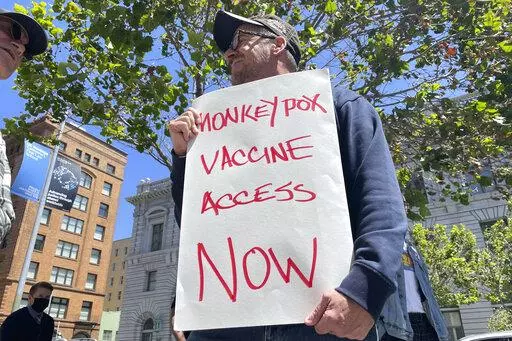 A man holds a sign urging increased access to the monkeypox vaccine during a protest in San Francisco, July 18, 2022. U.S. health officials on Tuesday, August 9, 2022, authorized a new monkeypox vaccination strategy designed to stretch limited supplies by allowing health professionals to vaccinate up to five people — instead of one — with each vial. (AP Photo/Haven Daley, File)
