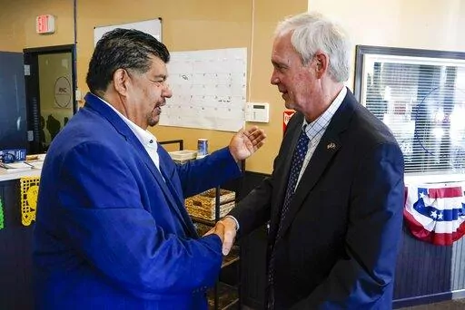 Wisconsin Republican U.S. Senate candidate Ron Johnson and Pastor Marty Calderon shake hands at a local Republican election office in Milwaukee, on Saturday, Oct. 8, 2022. In two decades of street outreach on Milwaukee’s south side, Calderon has offered Bible study, gang prevention, a safe place to stay for those battling addiction, and help getting jobs for those newly released from prison. But as he’s watched rising crime threaten those efforts to “clean up” his impoverished neighborho