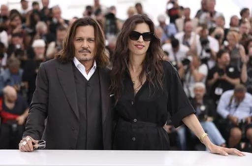 Johnny Depp, left, and director Maiwenn pose for photographers at the photo call for the film 'Jeanne du Barry' at the 76th international film festival, Cannes, southern France, Wednesday, May 17, 2023. (Photo by Vianney Le Caer/Invision/AP)