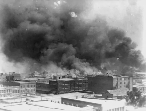 In this 1921 image provided by the Library of Congress, smoke billows over Tulsa, Okla. An Oklahoma judge has thrown out a lawsuit seeking reparations for the 1921 Tulsa Race Massacre, dashing an effort to obtain some measure of legal justice by survivors of the deadly racist rampage. (Alvin C. Krupnick Co./Library of Congress via AP)