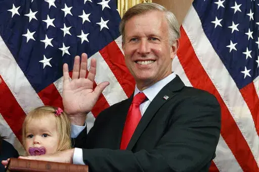 Congressman Chris Jacobs, R-N.Y., center, poses for a photo with his daughter Anna, 1, during a ceremonial swearing-in on Capitol Hill, July 21, 2020, in Washington. Jacobs says he will not run for another term in Congress amid backlash over his support for new gun control measures. (AP Photo/Jacquelyn Martin, File)